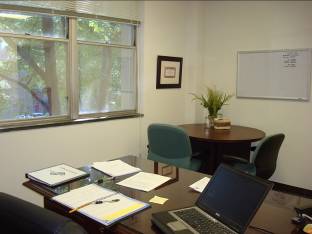 Rob&rsquo;s office includes additional space for a small conference table and chairs